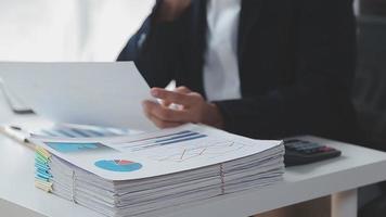 Financial analysts analyze business financial reports on a digital tablet planning investment project during a discussion at a meeting of corporate showing the results of their successful teamwork. video