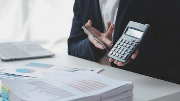 Financial analysts analyze business financial reports on a digital tablet planning investment project during a discussion at a meeting of corporate showing the results of their successful teamwork. video