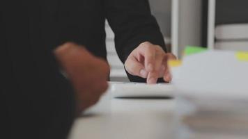 Financial analysts analyze business financial reports on a digital tablet planning investment project during a discussion at a meeting of corporate showing the results of their successful teamwork. video