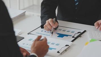 Financial analysts analyze business financial reports on a digital tablet planning investment project during a discussion at a meeting of corporate showing the results of their successful teamwork. video