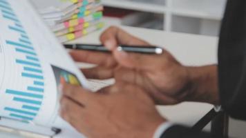 Financial analysts analyze business financial reports on a digital tablet planning investment project during a discussion at a meeting of corporate showing the results of their successful teamwork. video