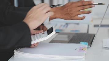 Financial analysts analyze business financial reports on a digital tablet planning investment project during a discussion at a meeting of corporate showing the results of their successful teamwork. video