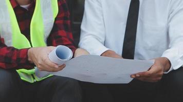 Construction and structure concept of Engineer or architect meeting for project working with partner and engineering tools on model building and blueprint in working site, contract for both companies. video