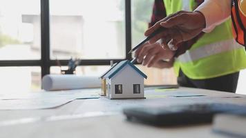 Construction and structure concept of Engineer or architect meeting for project working with partner and engineering tools on model building and blueprint in working site, contract for both companies. video