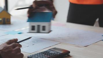 Construction and structure concept of Engineer or architect meeting for project working with partner and engineering tools on model building and blueprint in working site, contract for both companies. video