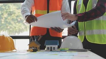 Construction and structure concept of Engineer or architect meeting for project working with partner and engineering tools on model building and blueprint in working site, contract for both companies. video
