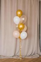 Festive balloons in gold, pink and white in a bouquet photo