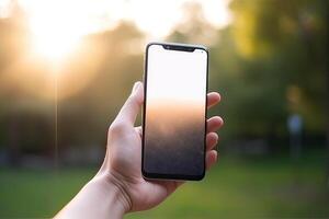 Close up view of hands holding mock up smart phone with green blurred background. photo