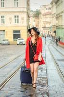 Woman walks with a suitcase photo