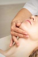 Woman receiving head and chin massage photo