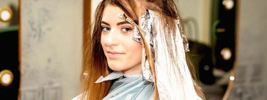 Woman getting foil on her hair photo