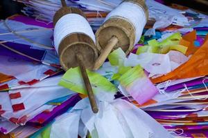 Colored paper kites and latai Knitting reel. photo