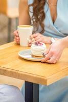 Waitress puts pastry on table photo