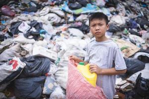 Children are forced to work on rubbish. Child labor,  Poor children collect garbage. Poverty, Violence children and trafficking concept,  Anti-child labor, Rights,  Day on December 10. photo