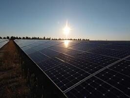 Solar Panels farm or solar call farm on green hills field and blue sky background .energy and eco environment concept .focus on first solar panel. . photo