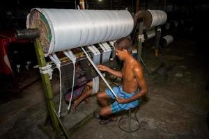 Bangladesh August 05, 2019 Yarn factory workers are rechecking newly made white yarn at Narsingdi, Bangladesh. photo