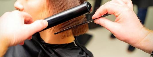 Hair stylist straightening short hair photo