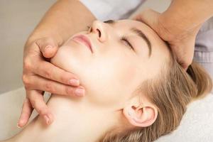 Woman receiving head and chin massage photo