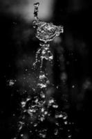 Water liquid splashing on isolated black background. photo