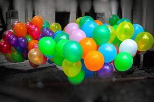 A bunch of colorful gas-filled balloons on dark background. photo