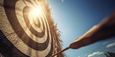 high success concept A red dart arrow aims at the target in the center of the dartboard. Target hit in the middle. . photo