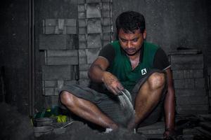 Bangladesh August 6, 2019 A labor is working inside a local steel machine parts making yard at Madhabdi, Narsingdi, Bangladesh. photo