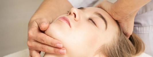 Woman receiving head and chin massage photo