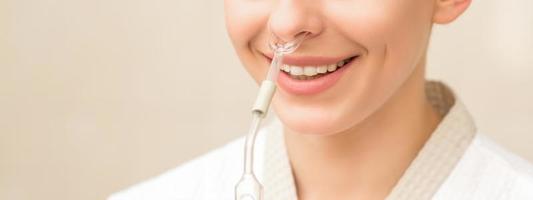 Woman receiving nasal oil inhaler photo