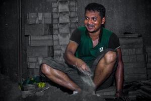 Bangladesh August 6, 2019 A labor is working inside a local steel machine parts making yard at Madhabdi, Narsingdi, Bangladesh. photo