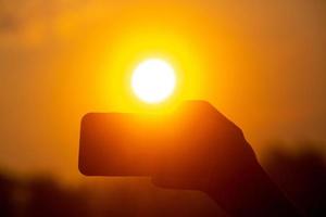 Taking pictures with a mobile camera at sunrise. Selfie picks up with a mobile camera in the golden light of sunrise. photo