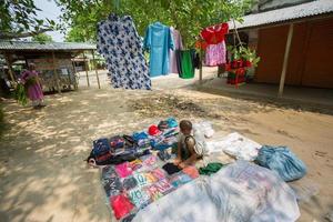 Bangladesh May 19, 2019 A Rural village Businessman selling cloth and products to hang up on the tree trunk, Meherpur, Bangladesh. photo