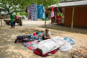 Bangladesh May 19, 2019 A Rural village Businessman selling cloth and products to hang up on the tree trunk, Meherpur, Bangladesh. photo