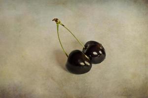 l juicy fresh summer cherries in a white bowl on a vintege background photo