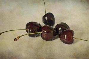 l juicy fresh summer cherries in a white bowl on a vintege background photo