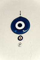 the  Turkish eye of the prophet hanging on the white wall as a decoration to deter bad luck photo