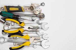 Set of tools for repair in a case on a white background. Assorted work or construction tools. Wrenches, Pliers, screwdriver. Top view photo