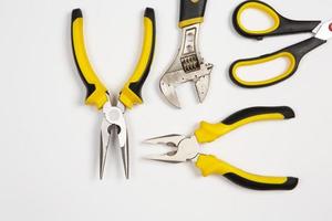 Set of tools for repair in a case on a white background. Assorted work or construction tools. Wrenches, Pliers, screwdriver. Top view photo