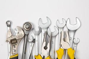 Set of tools for repair in a case on a white background. Assorted work or construction tools. Wrenches, Pliers, screwdriver. Top view photo