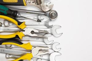 Set of tools for repair in a case on a white background. Assorted work or construction tools. Wrenches, Pliers, screwdriver. Top view photo