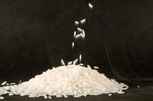 White rice on black background photo