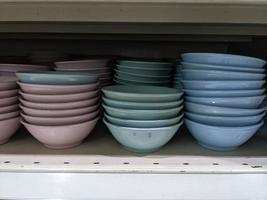 Lot of bowl and plate on the rack mini market. The photo is suitable to use for promotion picture and discount background.