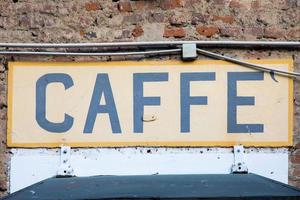 Old vintage coffee sign in Italy - Concept of retro, traditional design. photo