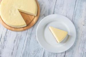 Traditional cheesecake on the wooden table photo