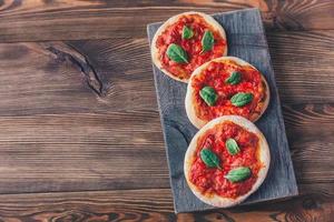 Mini Margherita pizzas with red cheese photo