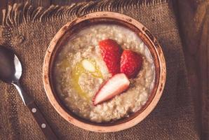 Bowl of oats with fresh strawberries photo