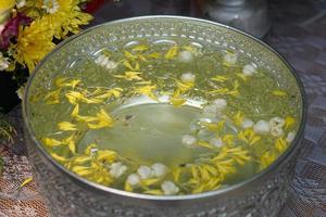 Water bowls with flowers floating on the water surface during the Songkran Festival photo