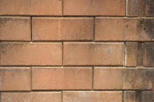 Brown block brick wall background, building wall photo