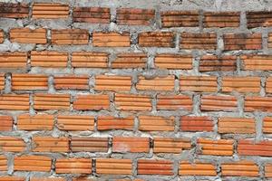 Brown block brick wall background, building wall photo