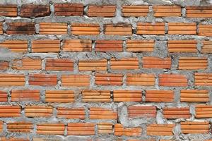 Brown block brick wall background, building wall photo