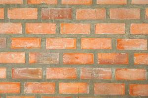 Brown block brick wall background, building wall photo